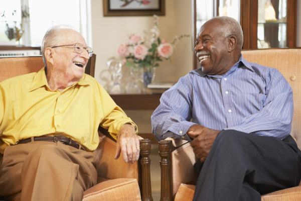two older men chatting in a living room