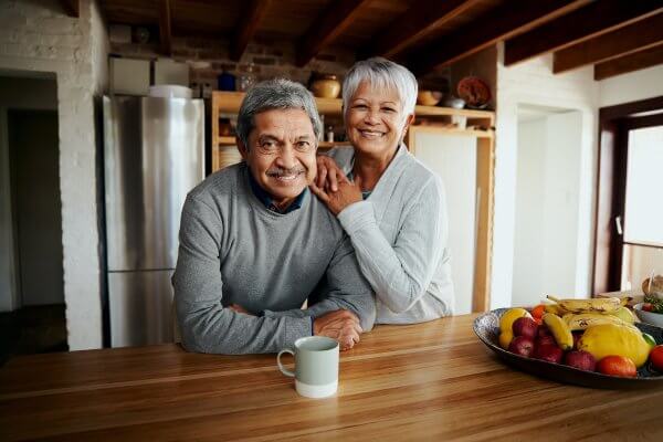 Older couple living happily with supports and services to help them thrive while they age.