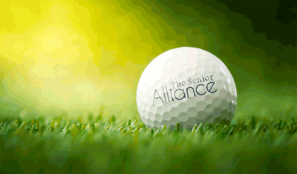 Golf ball in grass with the Senior Alliance Logo