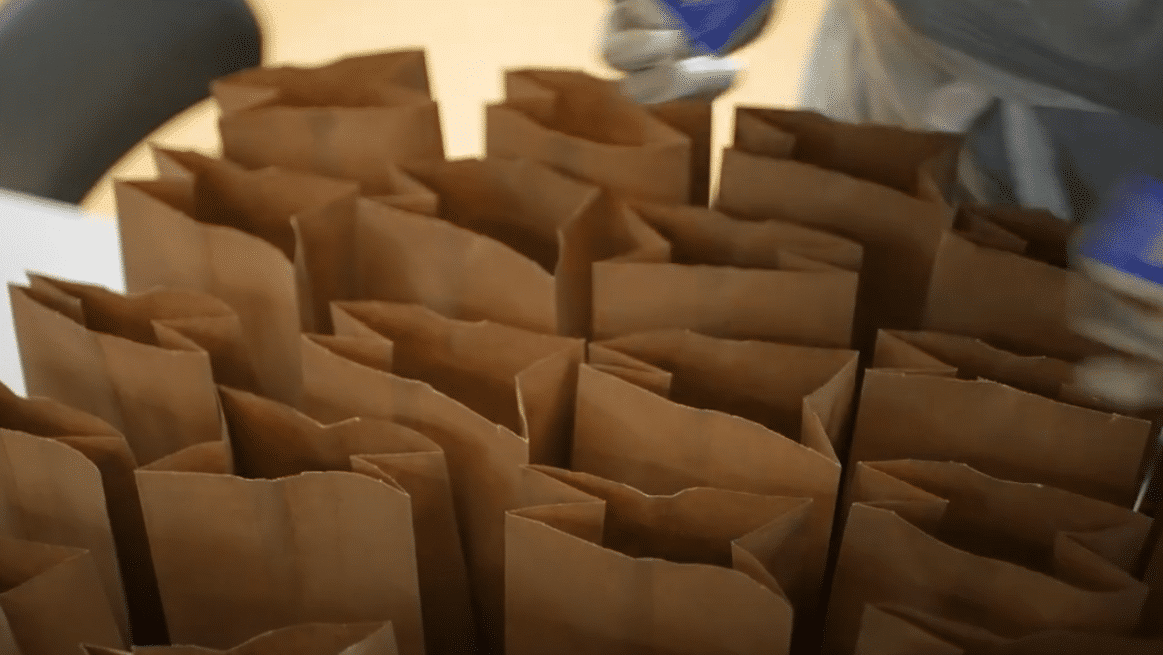 Bags on a table being ready to get packed for Meals on Wheels recipients