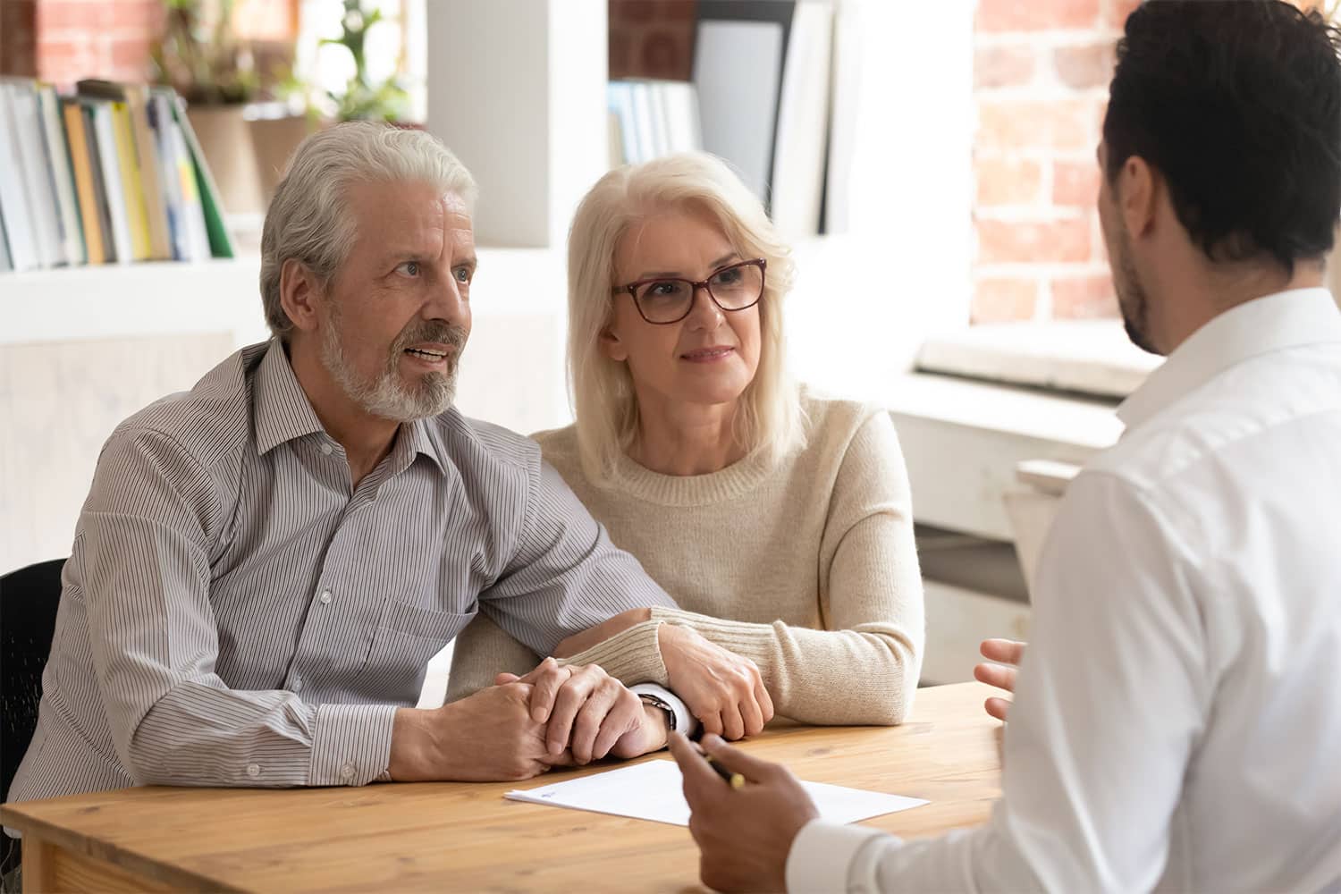 older couple speaking with a physician about services for in-home care
