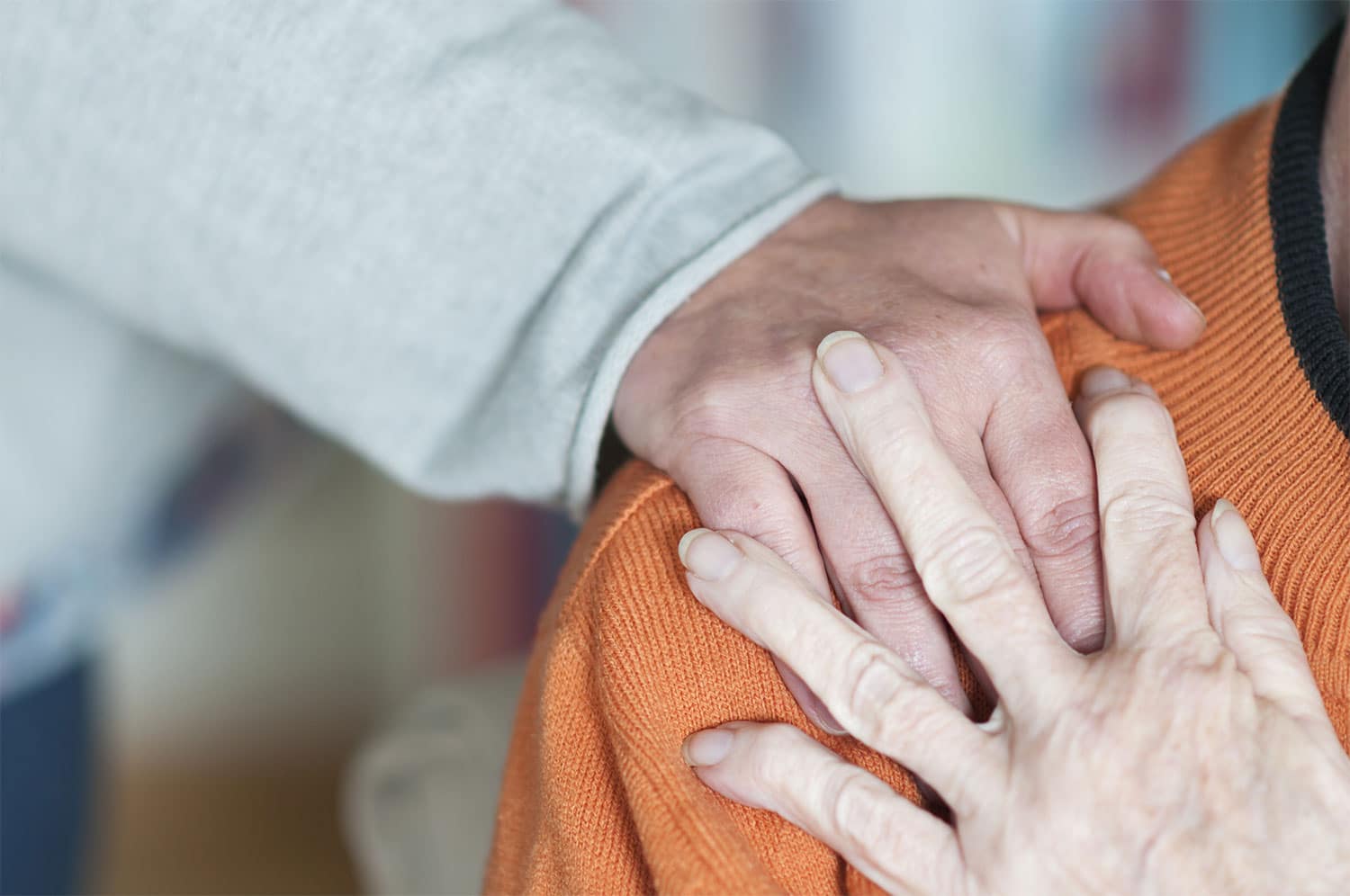 older adults as they embrace supporting hands