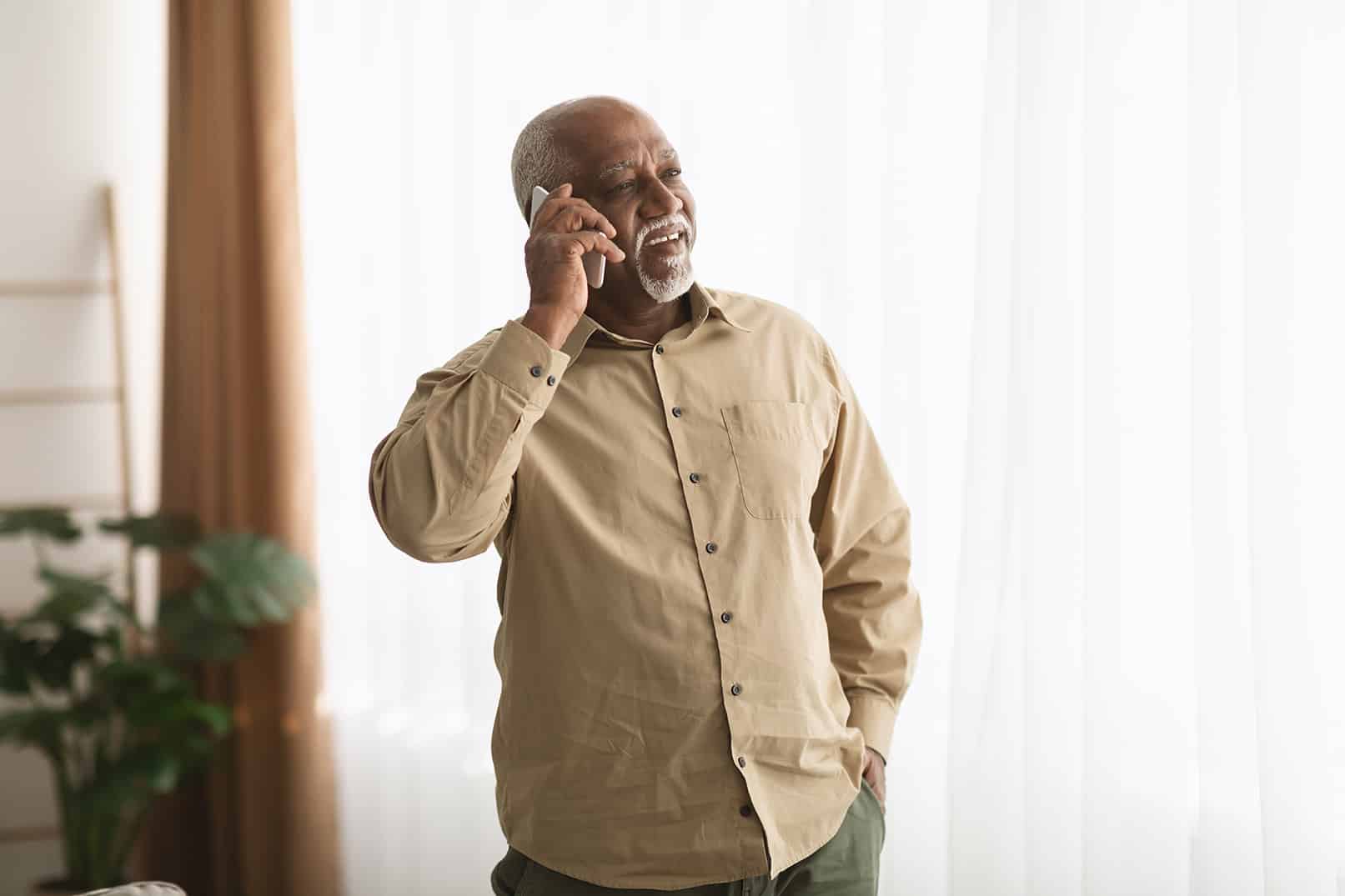 Older adult at home chatting on the phone