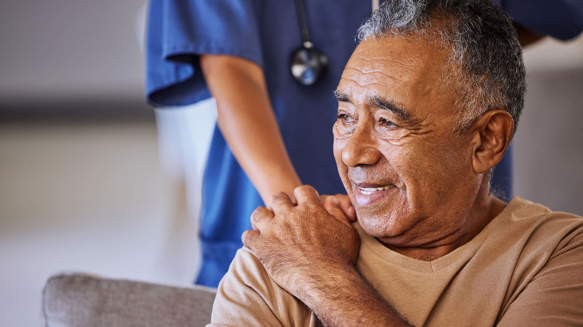 Older adult in a nursing facility being helped by a nurse