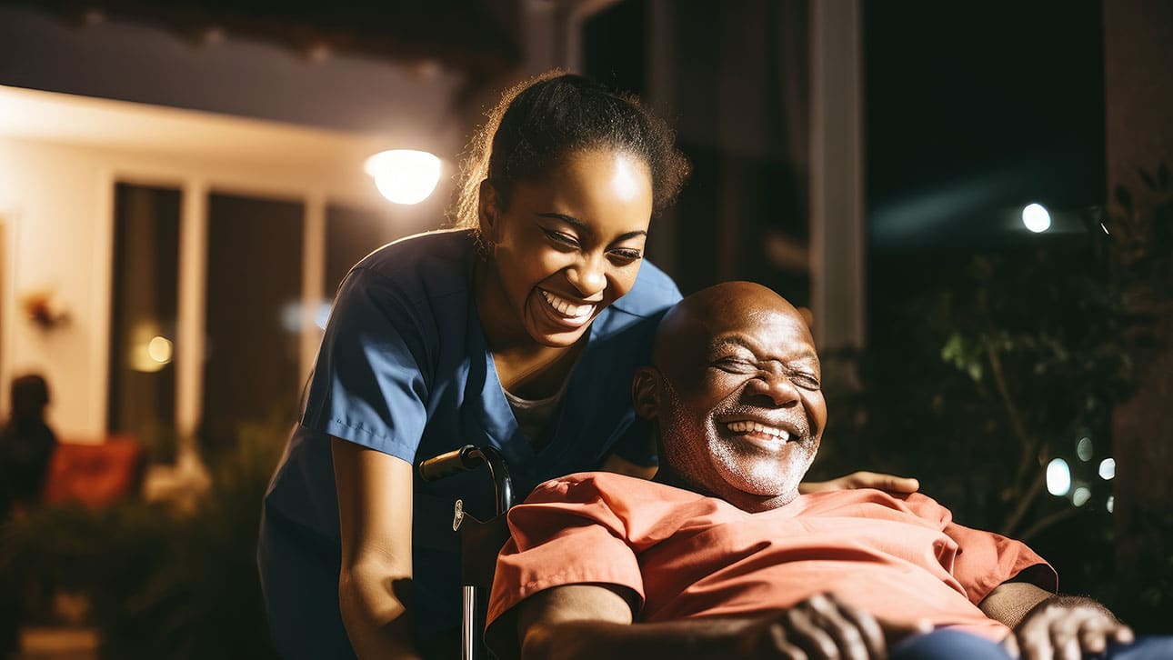 Older adult being able to stay living at home because of care management services like in home nurse assistance. He is happy and laughing with his aide.