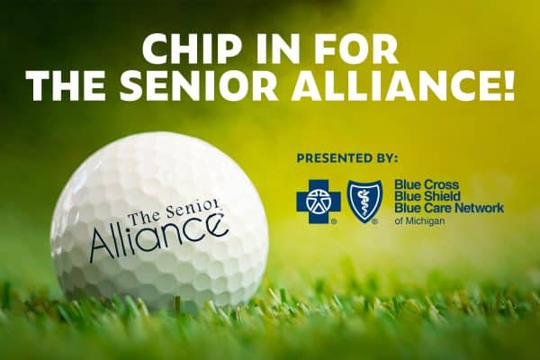 Chip in for The Senior Alliance, a golf ball with The Senior Alliance logo on the ball as it lays in the grass.